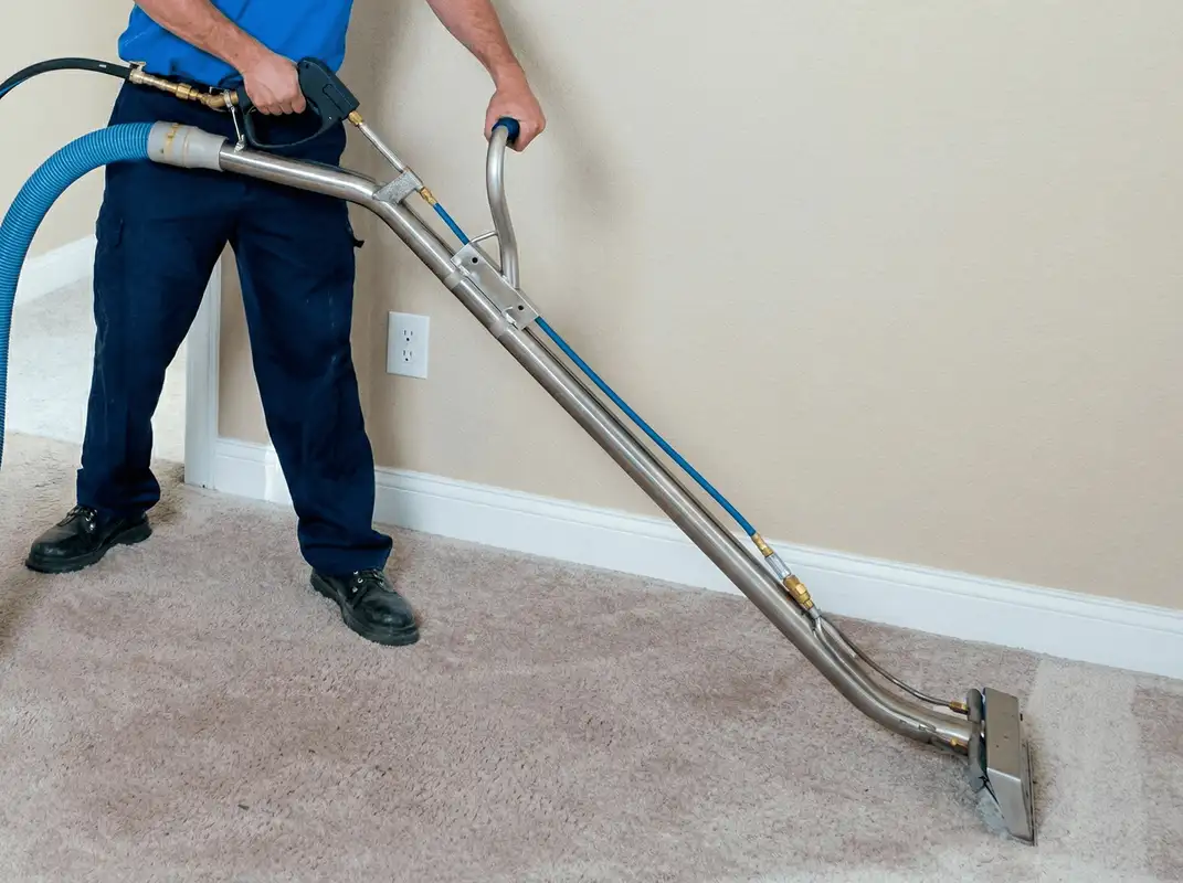 Professional operating a liquid removal machine on a carpeted floor in Fort Lauderdale, FL
